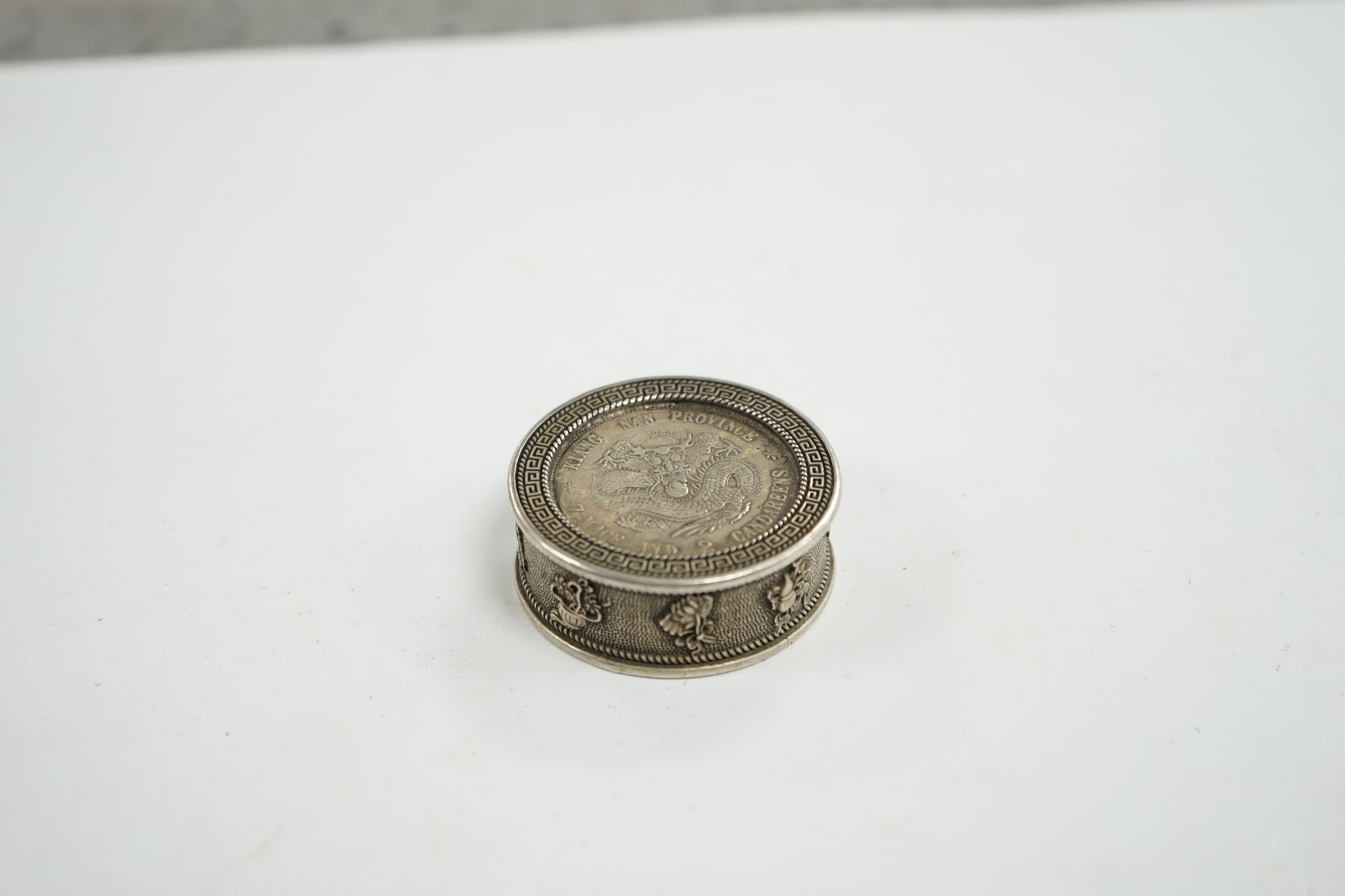 A Chinese white metal coin box and stamps, coin box 5cm diameter. Condition - coin box interior marked, stamps appear fair